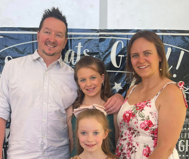 A child and her family at the Year 6 farewell
