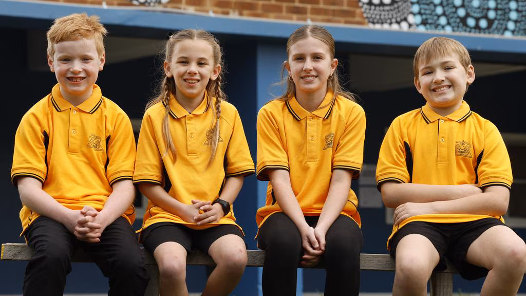 4 children sitting outside.