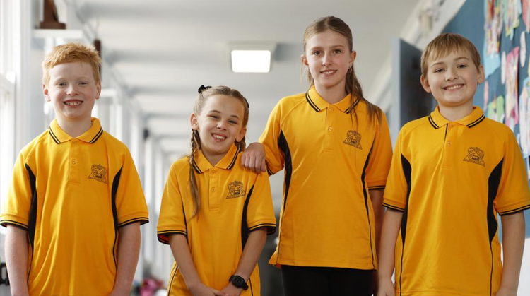 four children standing in corridor