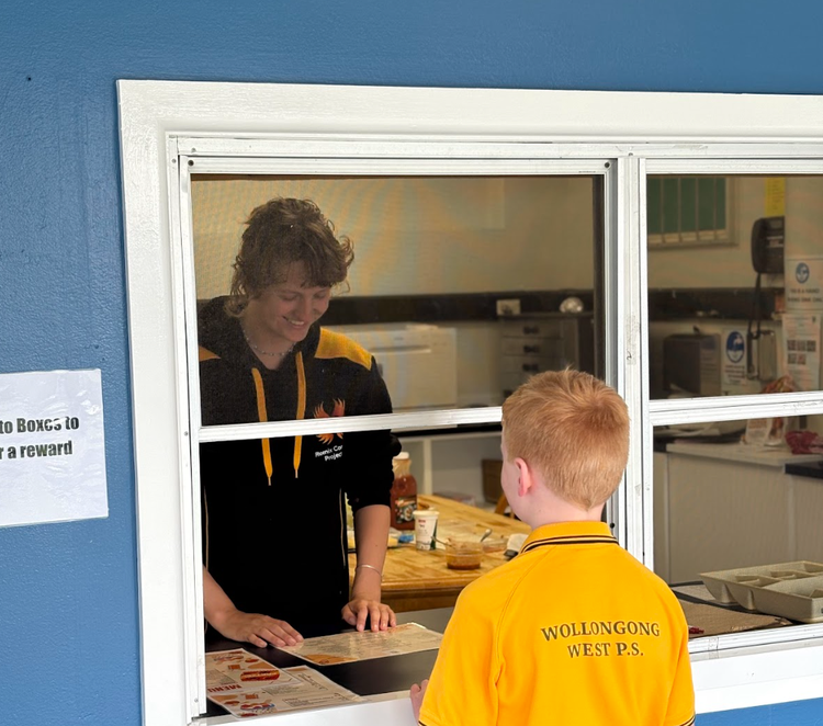 child ordering his lunch at the school canteen