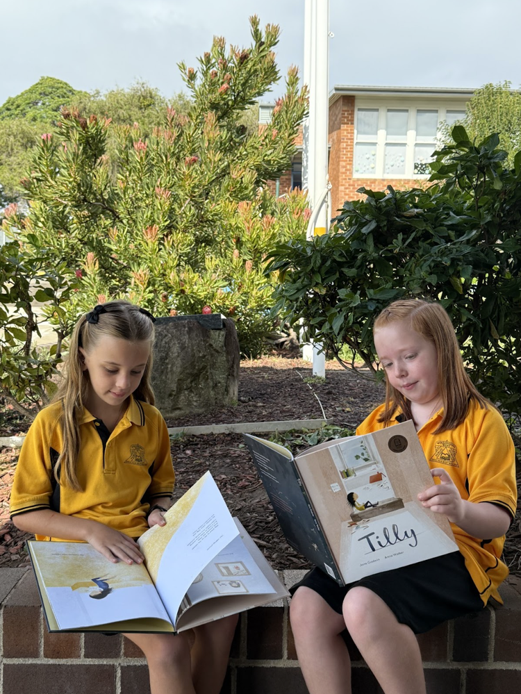 children reading outdoors