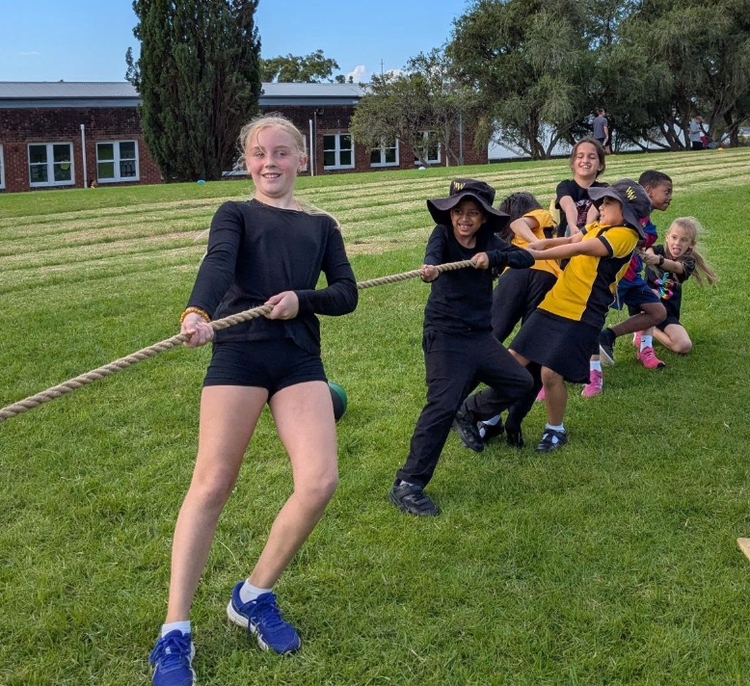 Students participating in tug-of-war at our carnival.