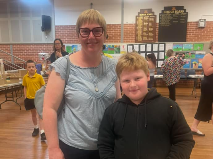 Mother and her son at a showcase assembly