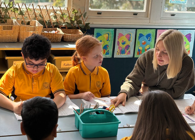 Teacher supporting children with learning