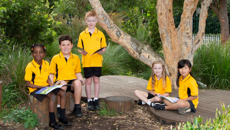children reading outdoors