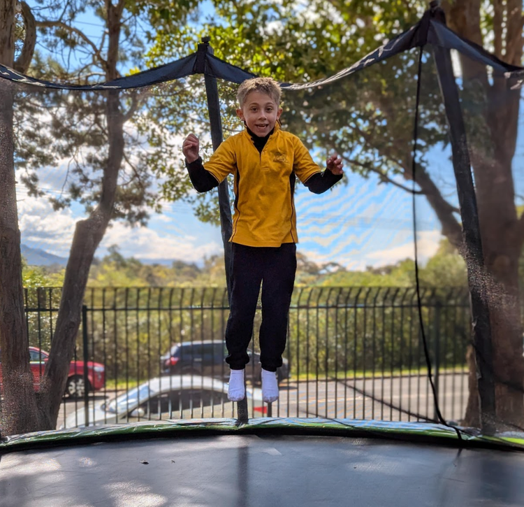 child jumping on a trampoline