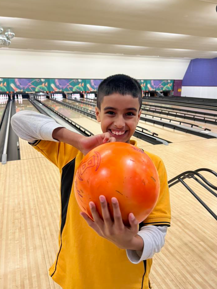 child with a bowling ball