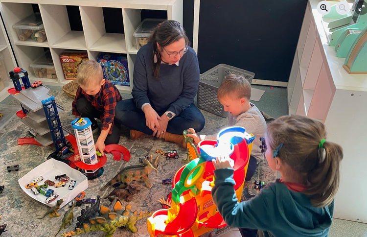 An educator interacting with children