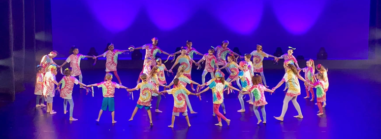 Dance troupe performing on stage.