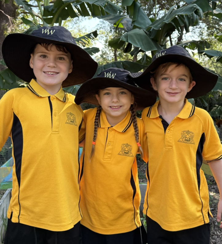 3 children in school uniform hugging